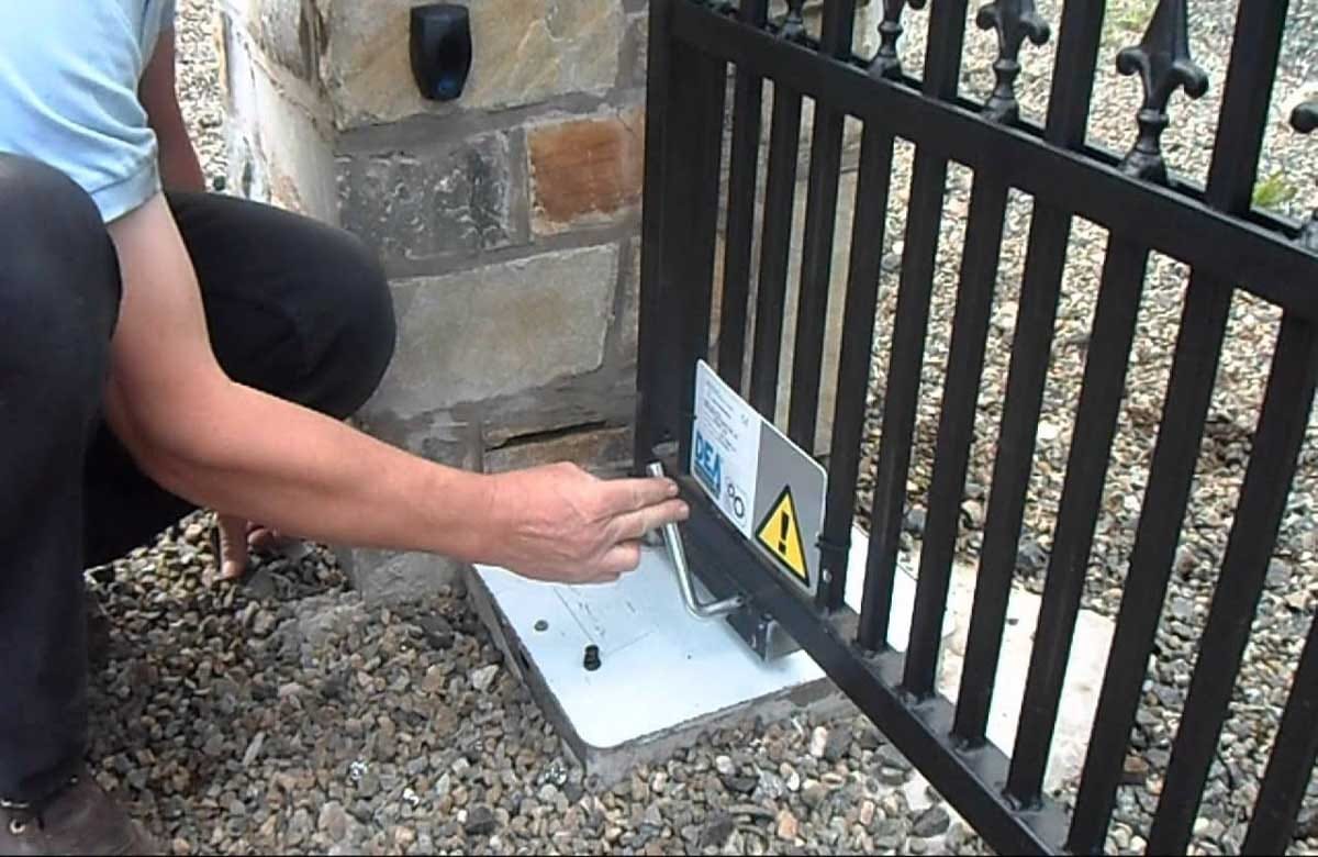 Damaged automatic driveway gate stuck halfway open