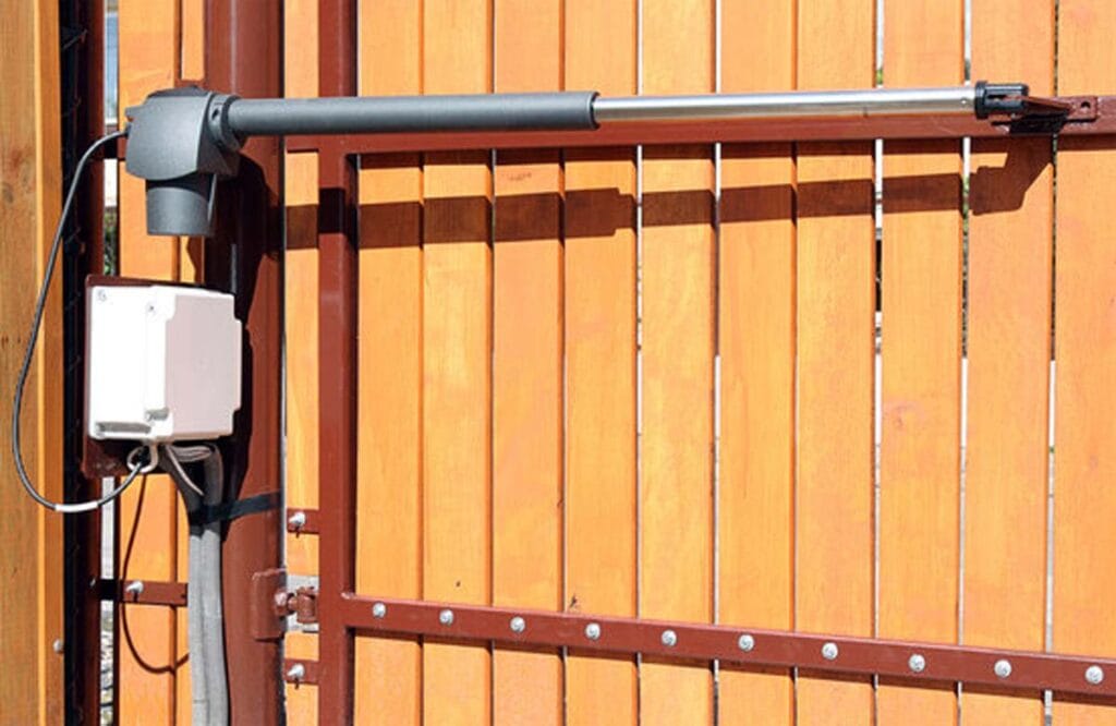 Close-up of a swing gate opener installed on a wooden Best Gate Repair Services in Austin, TX